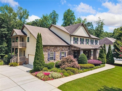Craftsman inspired home with a balcony, driveway, roof with shingles, a front lawn, and an attached garage