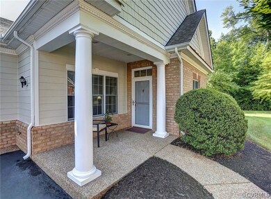 Covered Front Porch with aggregate walk way and de