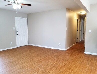 View of front door in greatroom and hallway to bed