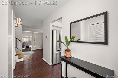Corridor featuring stairs and dark wood-style flooring