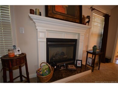 Gas fireplace with wood mantle and granite hearth.