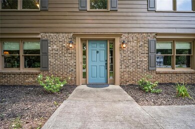 View of exterior entry featuring brick siding