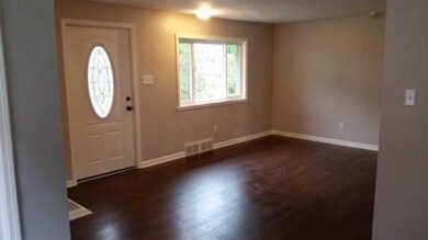 Living room with new flooring, trim, paint and doo