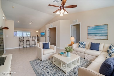 Living area with a ceiling fan, vaulted ceiling, b