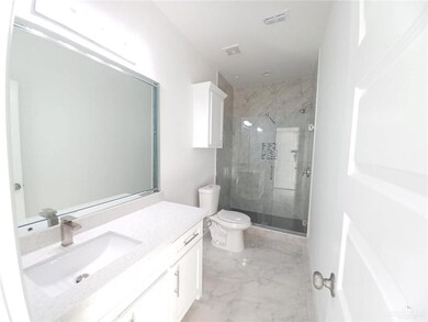 Full bath with toilet, marble finish floor, vanity, visible vents, and a shower stall