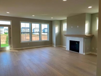 Spacious main floor family room with gas fireplace and lots of windows.