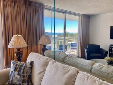 Living room with a textured ceiling and a wall of 