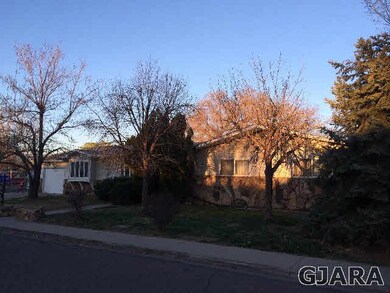 Mature trees frame the front of the home.