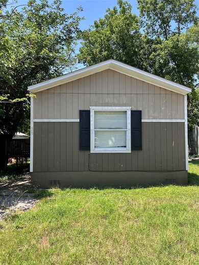 View of side of home featuring a yard