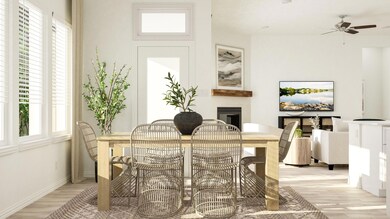Dining area with ceiling fan and light hardwood / 