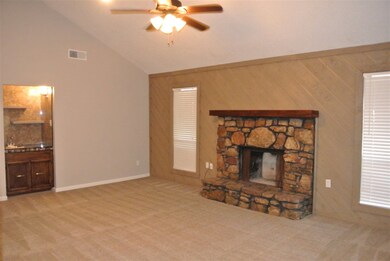Living room with fireplace and wet bar.  New carpe