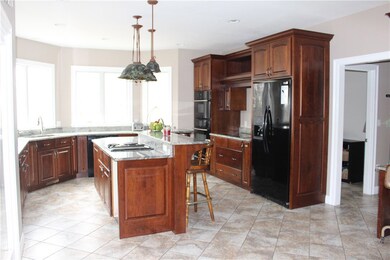 Chef's kitchen boasts 2 stove tops, wall oven and