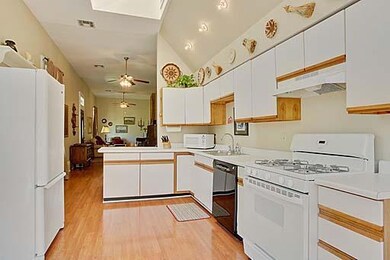 Kitchen. Skylight and large picture window provide
