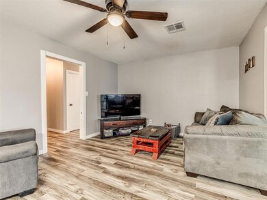 Living room with light hardwood / wood-style floor