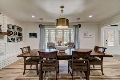 A great view of the Bay Window with a view of the front yard.  The entry door is to the far right of the table.  This is a 9 foot table for reference.