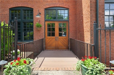 Doorway to property with brick siding and french doors