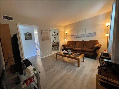Living room with light wood-type flooring
