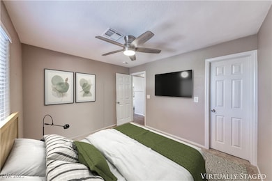 Bedroom with light colored carpet and ceiling fan