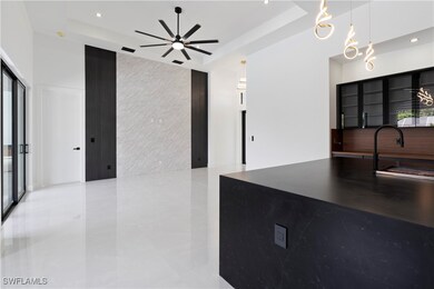 Kitchen featuring a raised ceiling, decorative lig