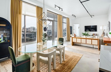 Dining room featuring concrete floors and track l