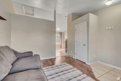 Living room with wood finished floors and attic access