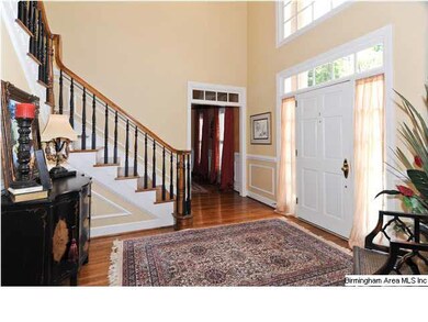 Impressive two-story foyer with wood floors and be