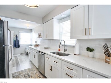 The kitchen was remodeled in 2020. The cabinets are shaker style cabinets, soft close and Quartz counter tops. The floor was also updated with luxury vinyl tile floors. The backsplash is white subway tile