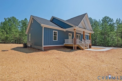 View of front facade featuring a porch, board and batten siding, and roof with shingles