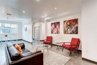 Living room featuring concrete floors, baseboards