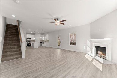 Stock PhotoUnfurnished living room featuring a ceiling fan, stairs, recessed lighting, a high end fireplace, and light wood finished floors