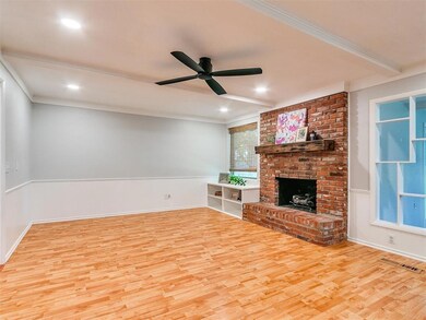 Unfurnished living room with ceiling fan, ornament