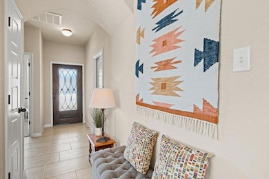 Entrance foyer with a textured ceiling, wood tile