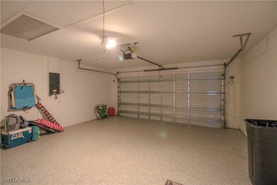Garage with electric panel and a garage door opene