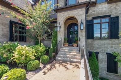 Guests are greeted at your entry by a covered porch with stately double iron doors & gas lanterns.  The mortar rubbed brick denotes the elite upgrades found throughout this home.