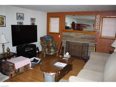 Entry door opens to Living room with hardwood floo