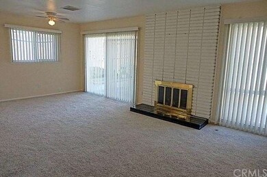 Living room with fireplace, sliders out to patio/p