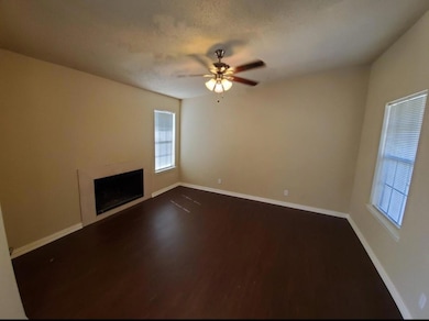 Unfurnished living room with baseboards, ceiling f