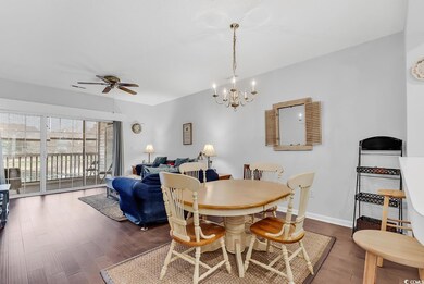 Dining room with ceiling fan with notable chandeli