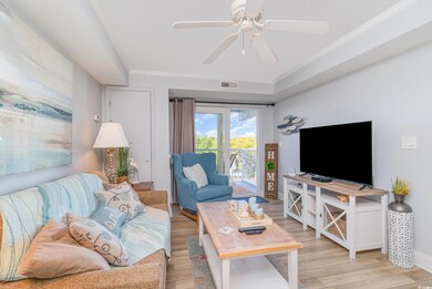 Living room featuring visible vents, light wood-ty