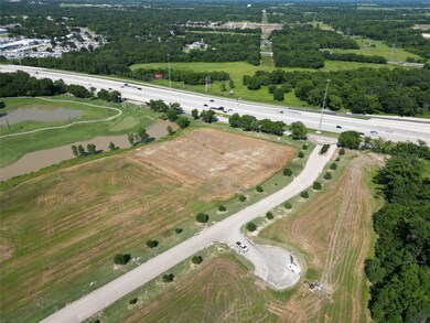 Aerial view of property's location featuring a nearby body of water