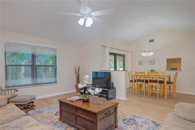 Living room with ceiling fan, lofted ceiling, and