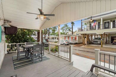 Wooden terrace with outdoor dining space, a ceiling fan, and a residential view