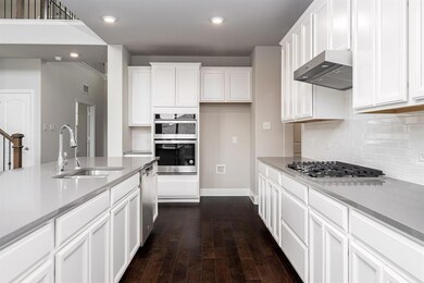 Kitchen features upgraded appliances and gas cook 