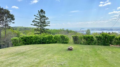View of grassy yard featuring an outdoor fire pit