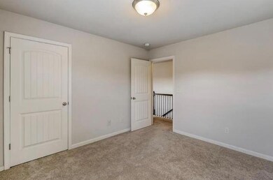 Unfurnished bedroom with baseboards and carpet flooring