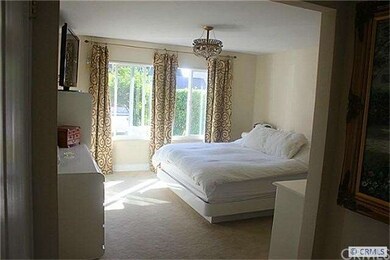 Through double doors enter to your master bedroom located downstairs with custom window facing lush grass. Around the corner is a custom walk in closet. To the right will be the master bath.