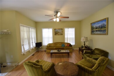 Living room with plenty of natural light, ceiling fan, and hardwood / wood-style floors