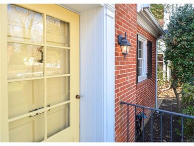 The front entry is welcoming, with a well-trimmed 