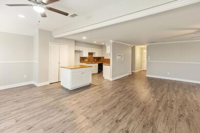 Unfurnished living room with baseboards, light woo