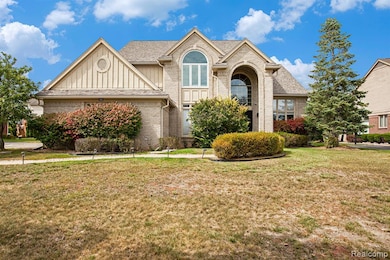 View of front of property with brick siding, board and batten siding, and a front yard